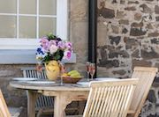 Outdoor seating at Eider Self-catering Cottage in Warren Mill, Northumberland, UK